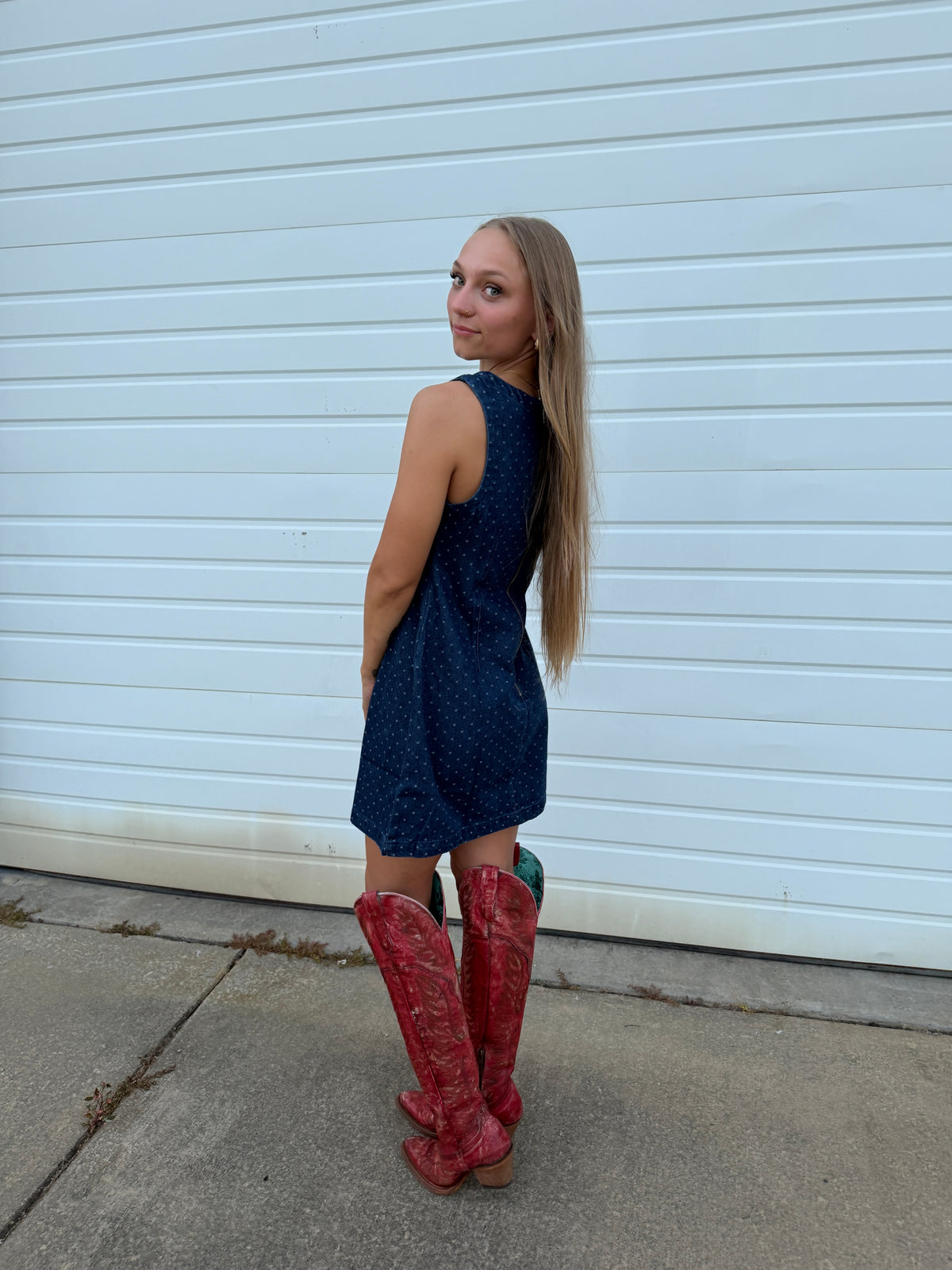 Woman wearing a Southern-inspired western denim polka dot dress from Southern Gems Boutique.